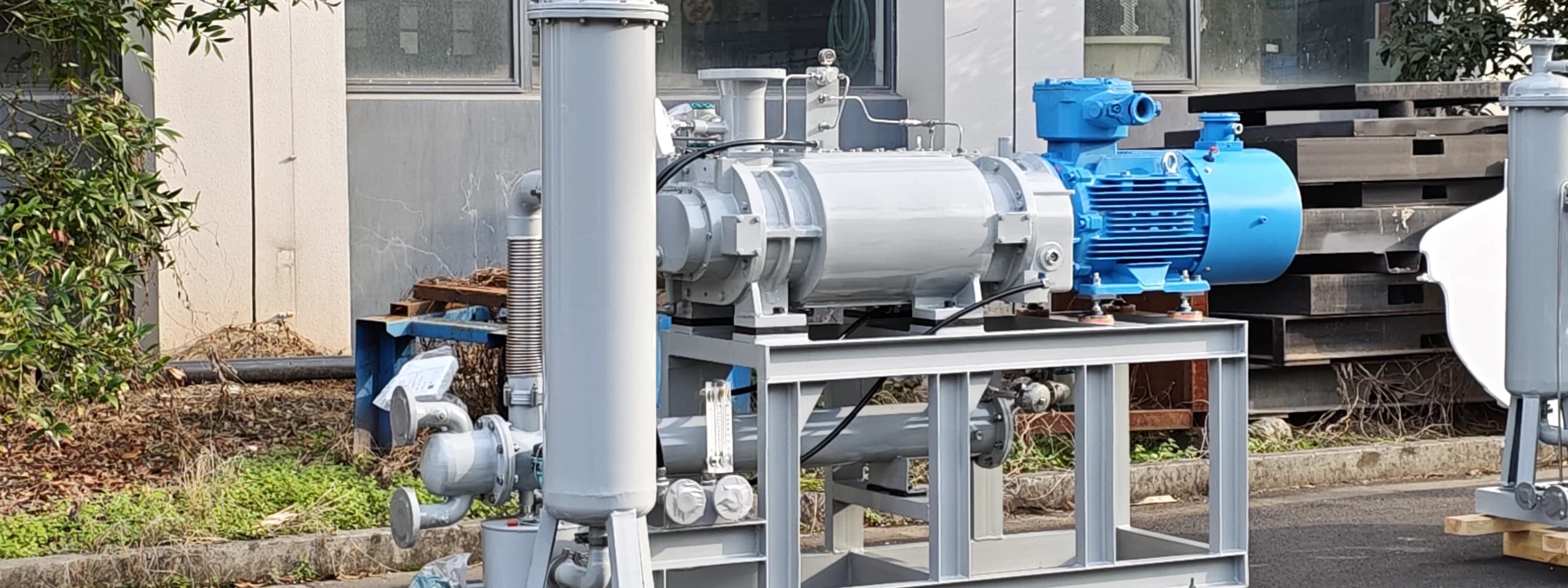 Dry screw vacuum pump system staged outside the factory